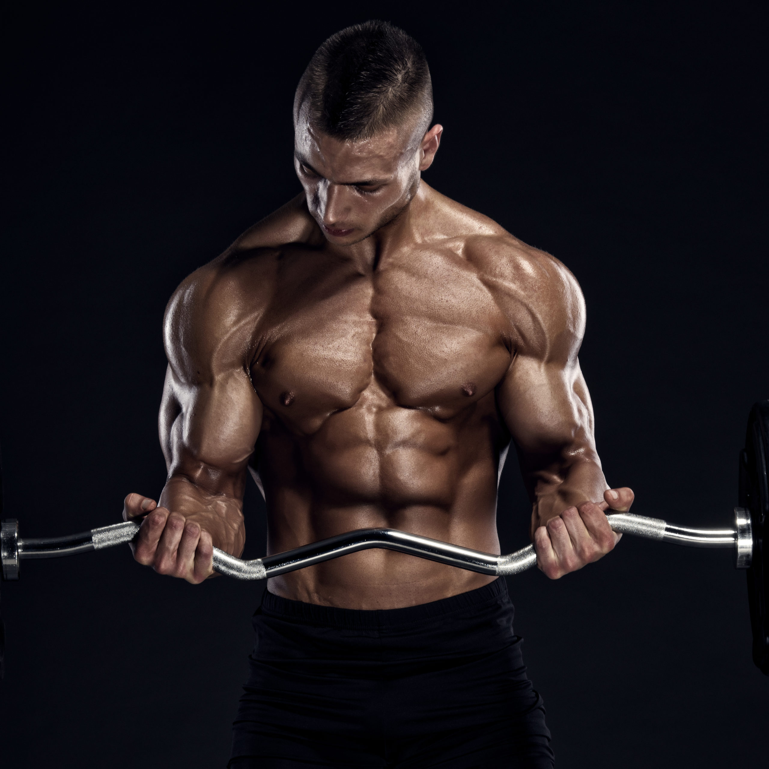 muscular man performing ez bar bicep curl